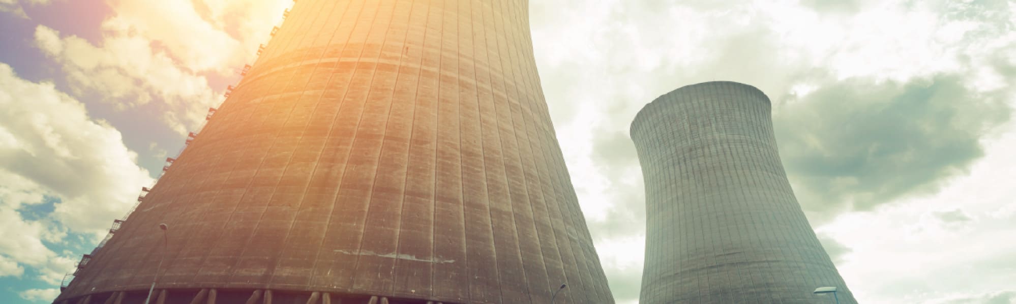 A picture of 2 nuclear cooling towers from the ground up